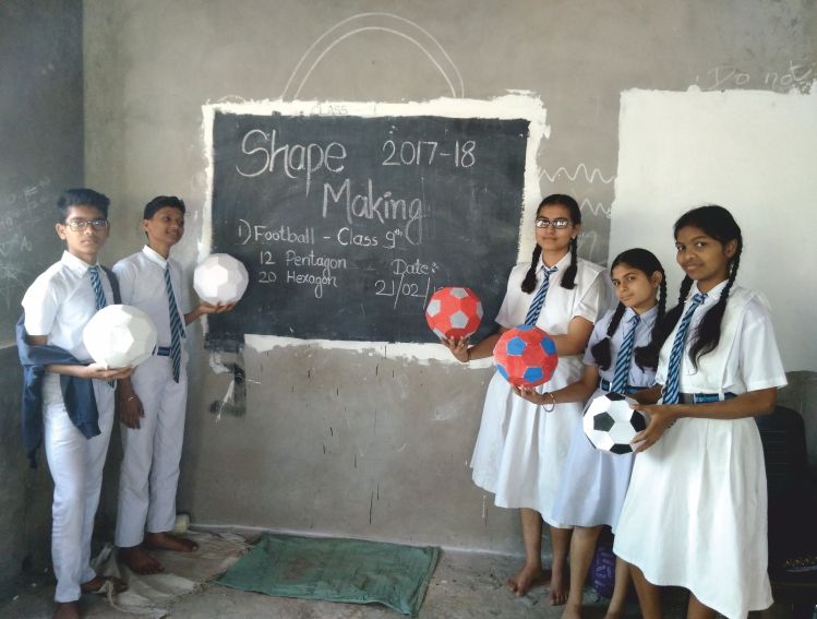 Class 9 students holding footballs they built from pentagons and hexagons
