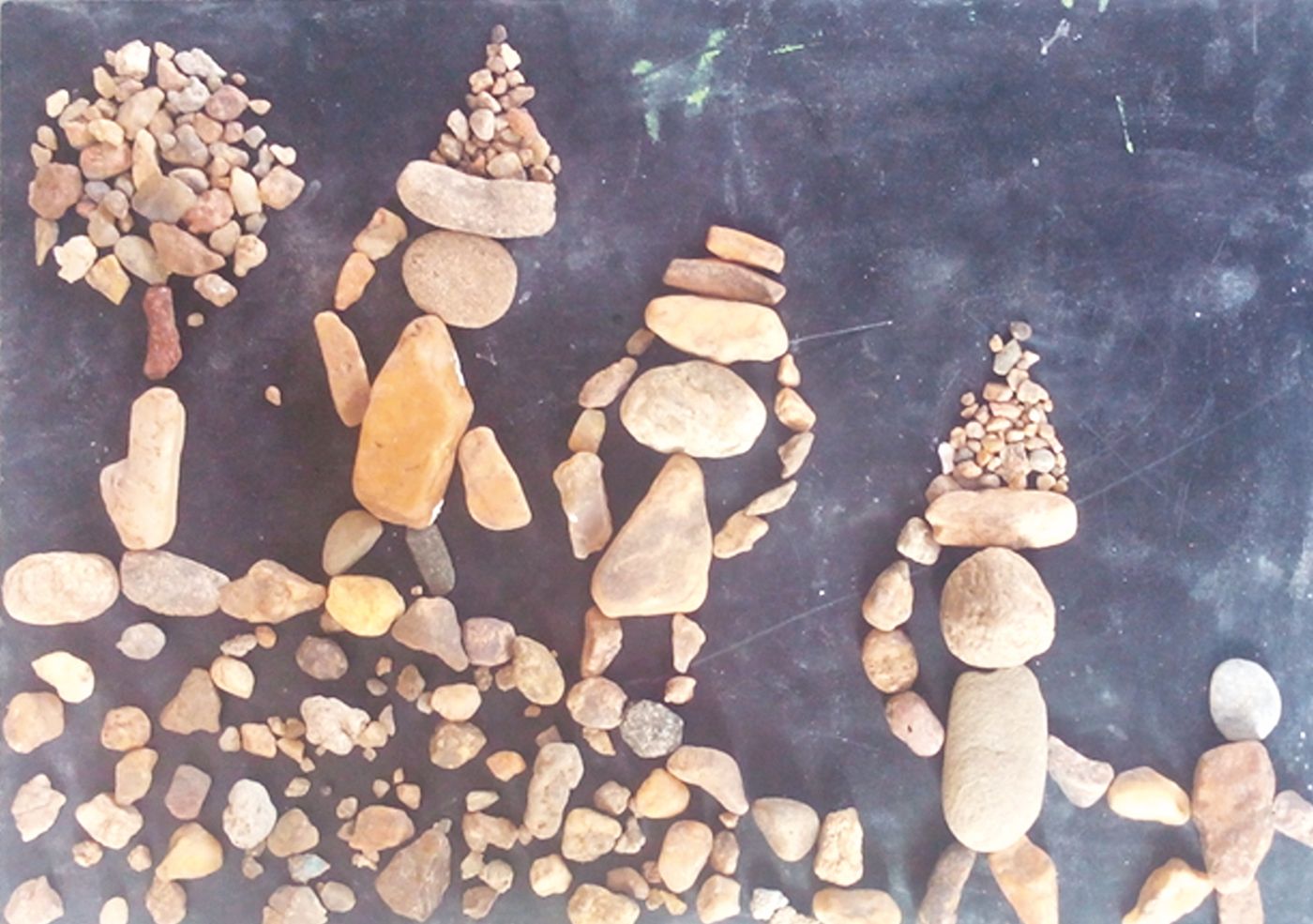 Small figures built from pebbles and stones arranged on the ground